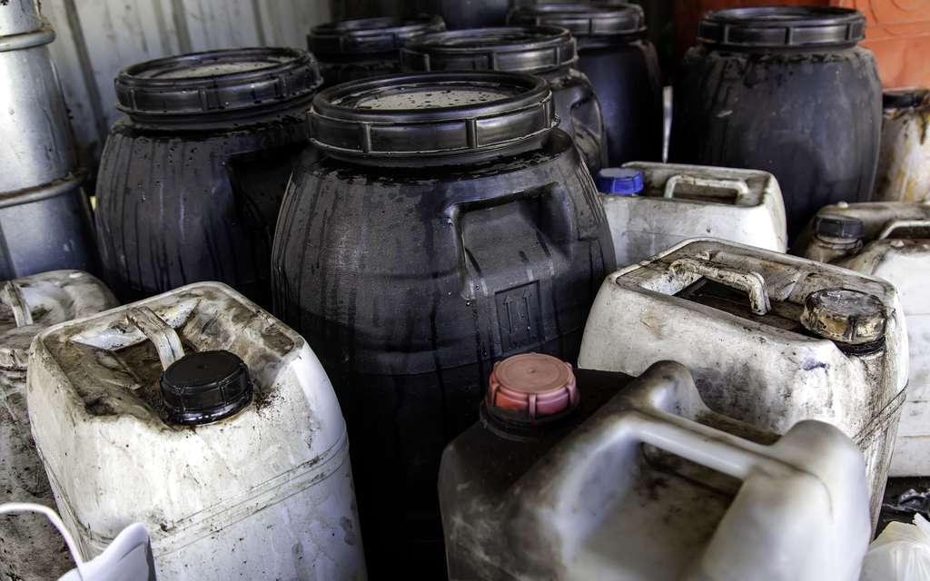 plastic jerry can drum barrel with dirt on it