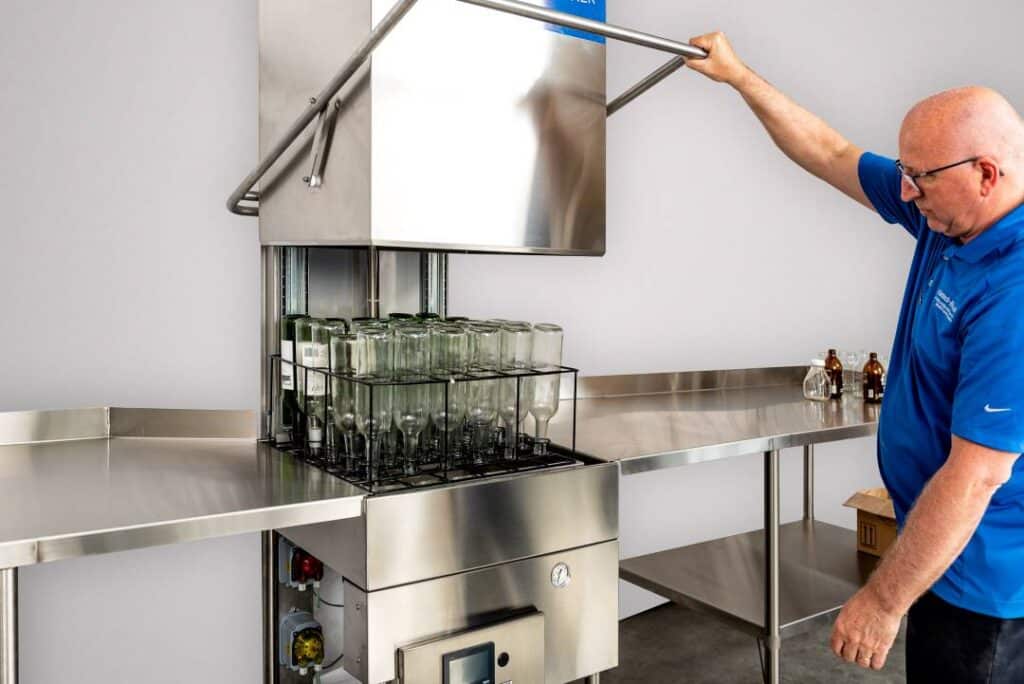 bottle washing and cleaning machine in action with operators