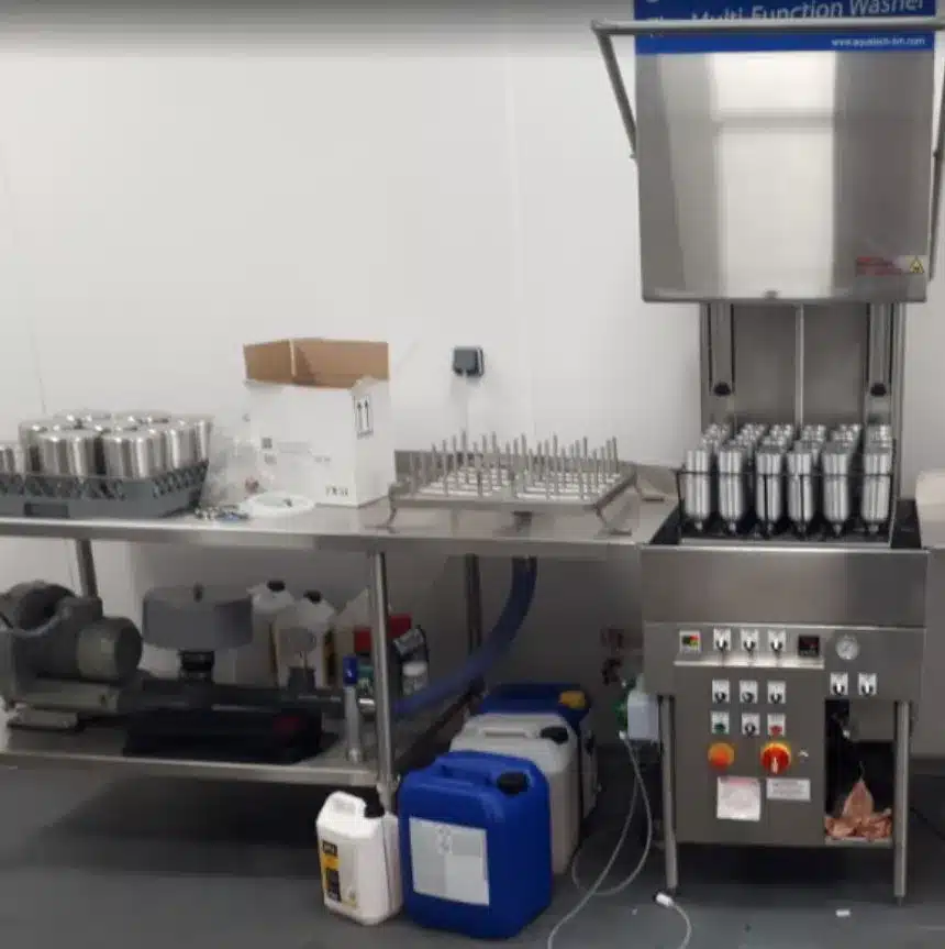 Drying table with rod rack and blower under the shelf, next to a Multi-Function Washer